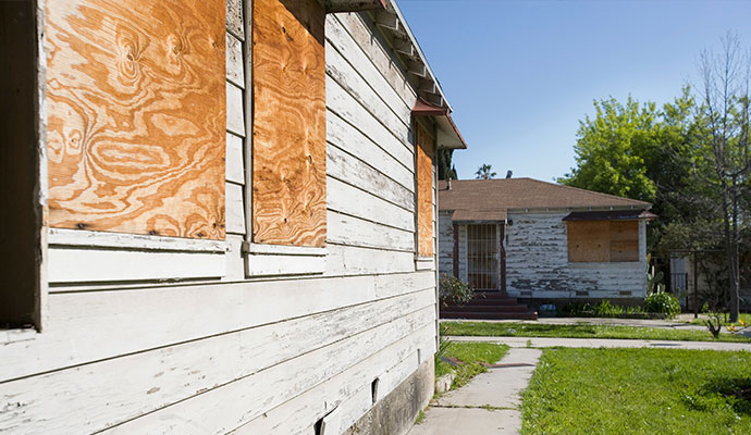 Houses with boarded-up windows and doors